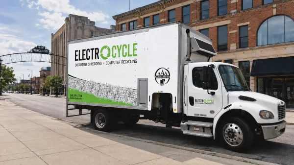 ElectroCycle mobile document shredding truck parked in downtown Flint near the Vehicle City arch